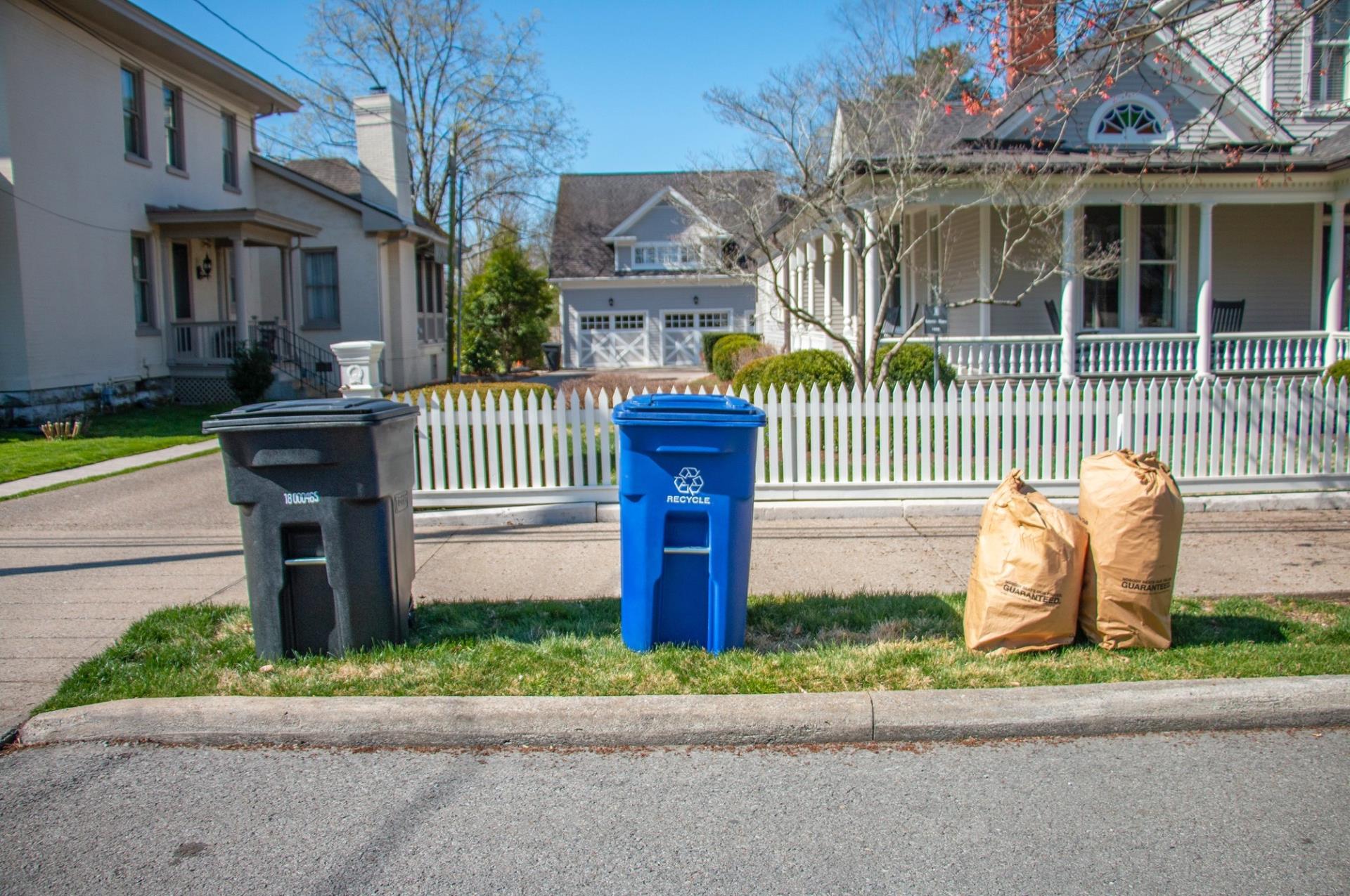 Blue bin on curb in front of house