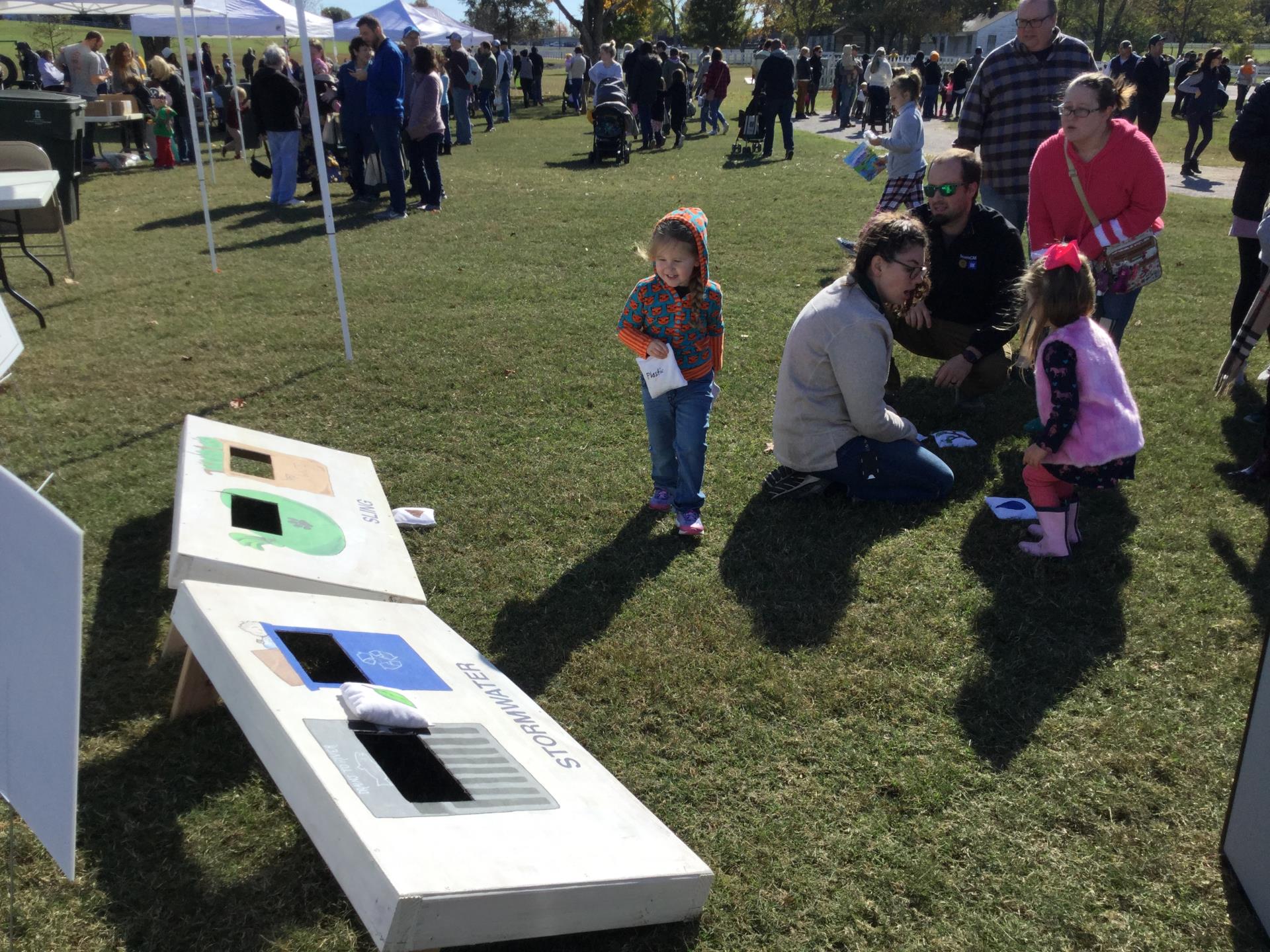 Stormwater staff helping kids at a booth at Family Day