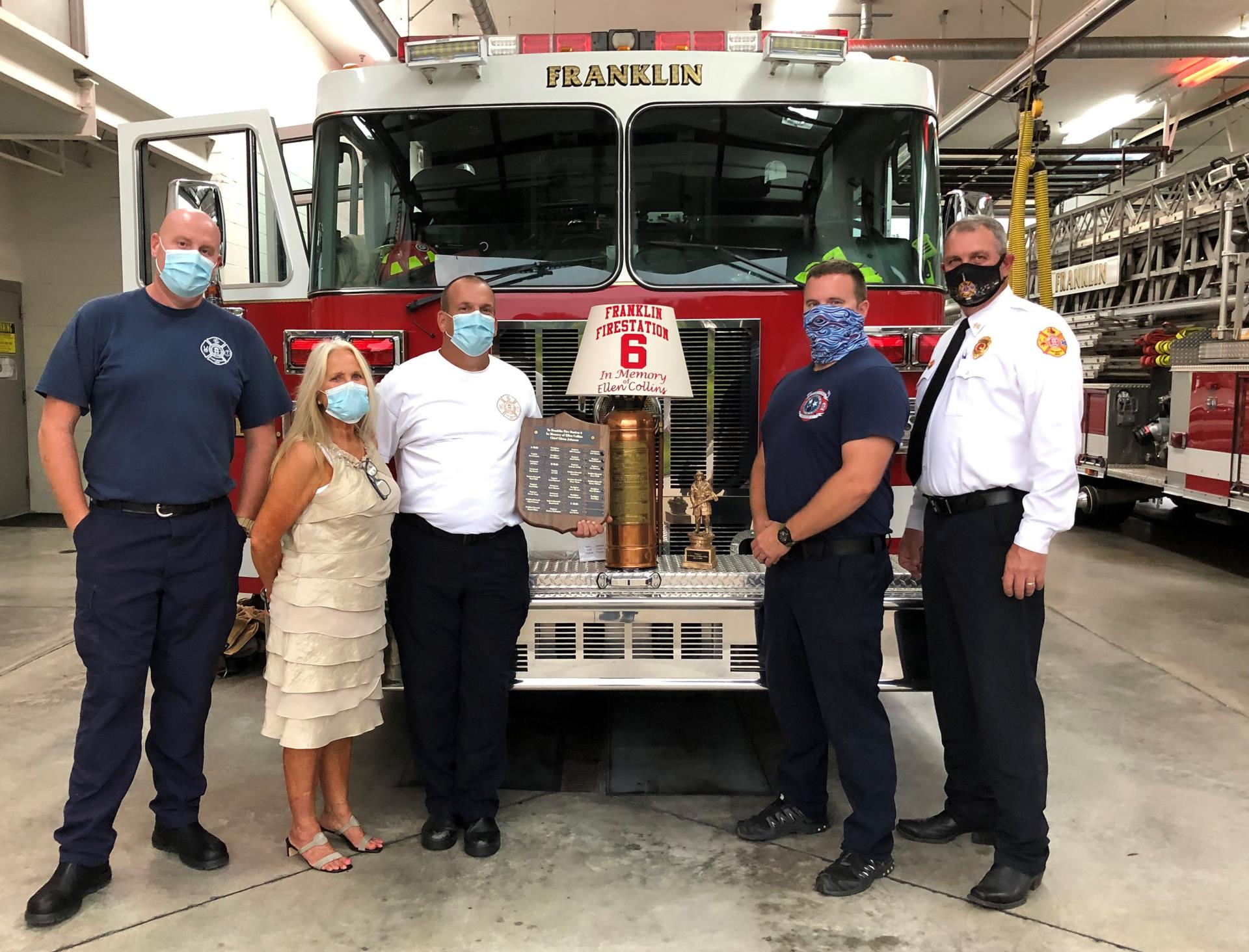 Gloria Benson presents gifts to firefighters