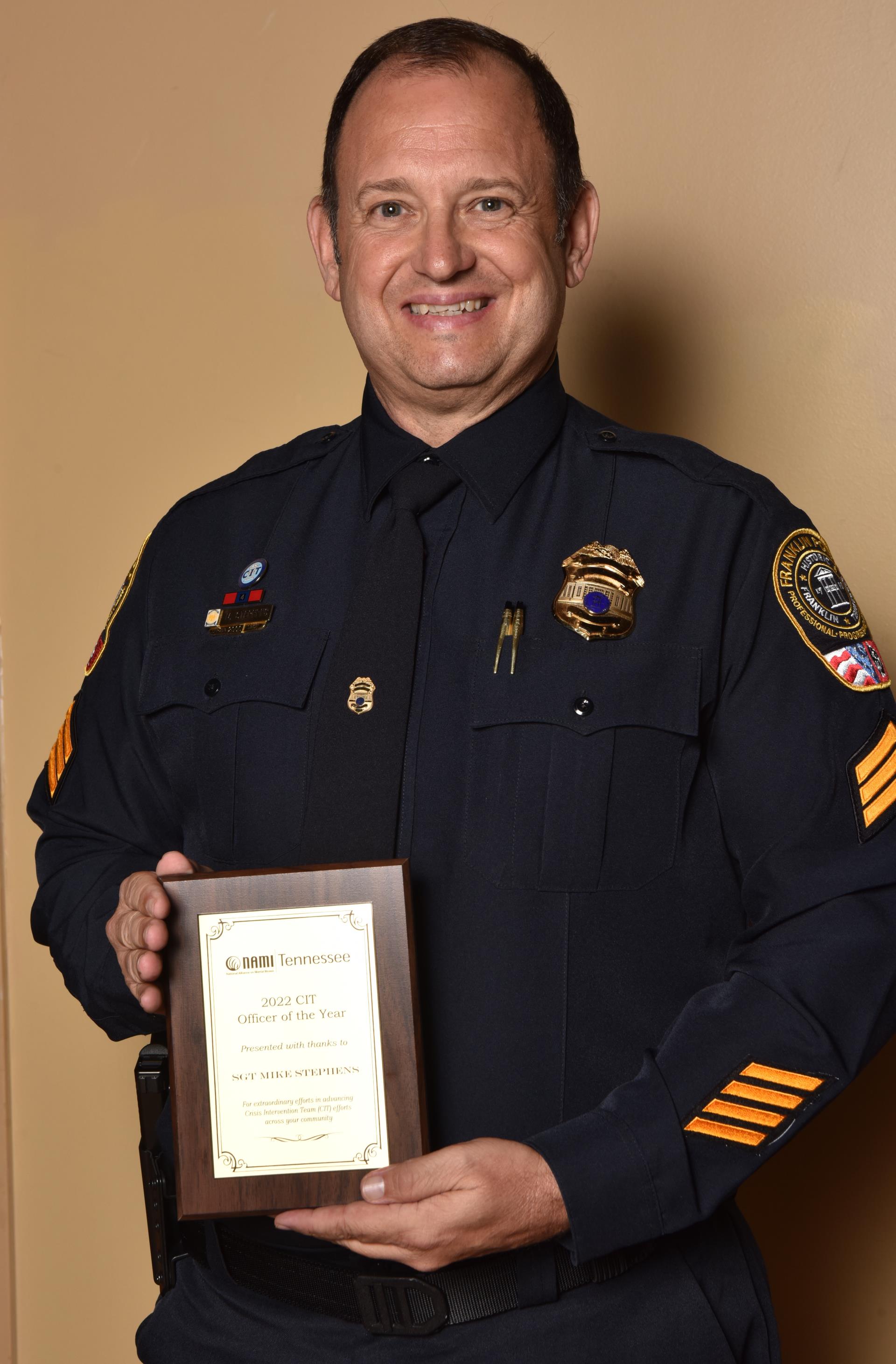 Sgt. Mike Stephens holding award