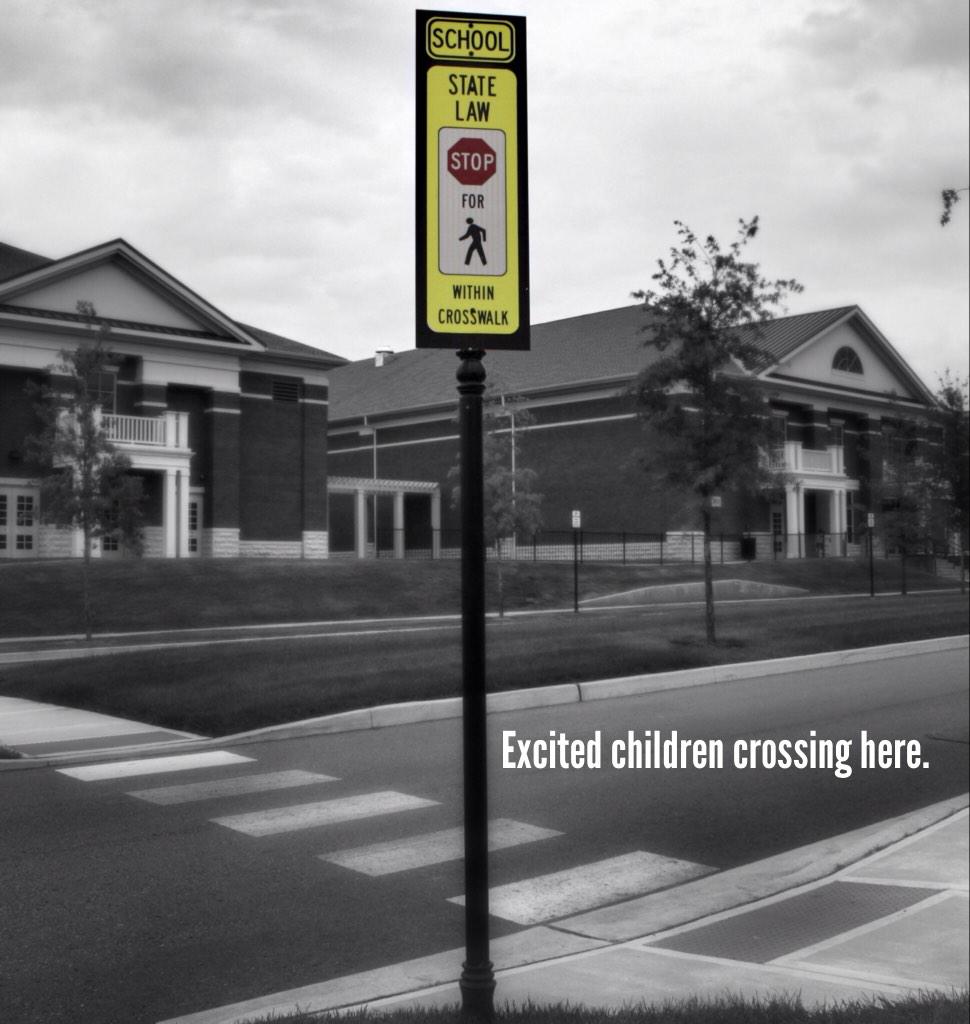 Picture of crosswalk in front of a school